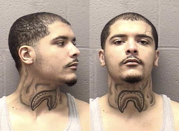Dual mugshot of an individual with close-cropped hair and a goatee, revealing a unique neck tattoo and neutral facial expressions against a cinder block background.