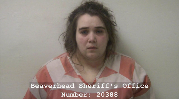 Head-and-shoulders image of a woman in a striped prison jumpsuit, with official booking text for Beaverhead Sheriff’s Office and identification number written across the lower portion.