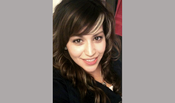 Casual selfie showing a smiling woman with long highlighted hair and subtle makeup.