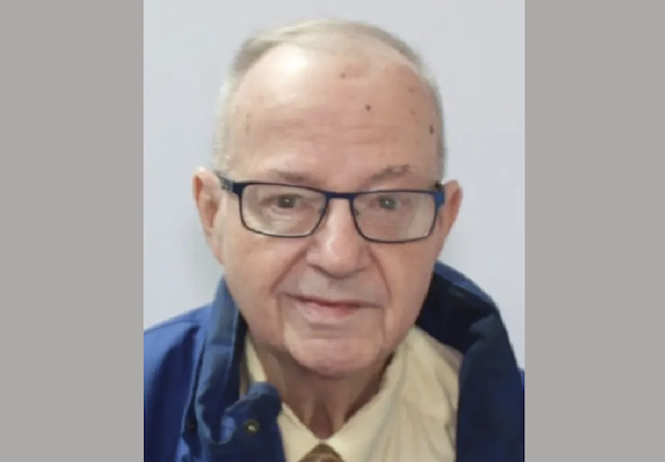 A front-facing image shows an elderly man dressed in glasses, a tie and a blue jacket against a light backdrop.