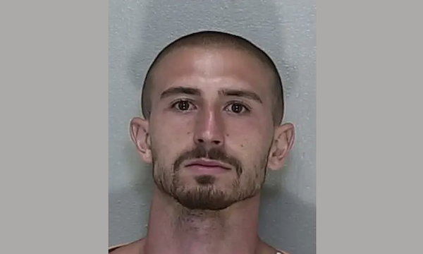 Head-and-shoulders photo of a man with a shaved head and trimmed facial hair.